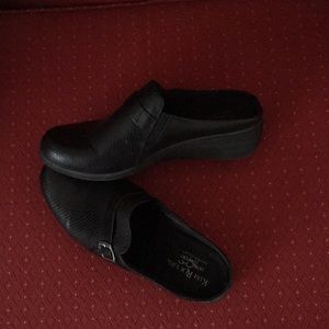 Black slip on wedge heel shoe.